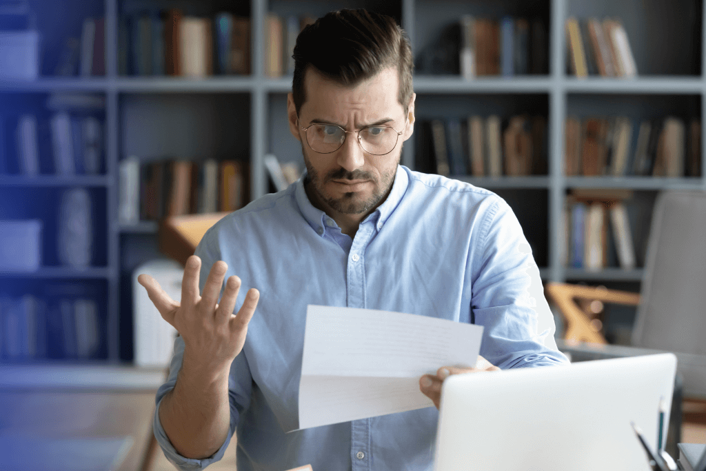 a man in an office reading customer complaints