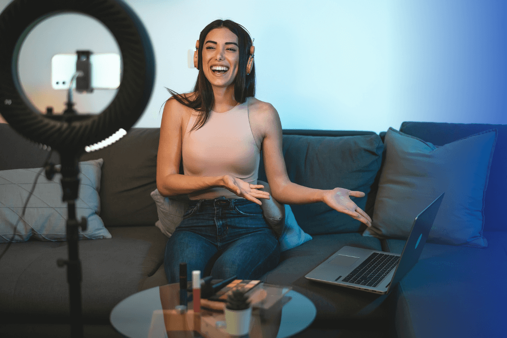 the influencer is sitting on the sofa with her laptop